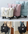 Quilted rolling duffle bag on wheels, set of four in cream, pink, light blue, and teal.