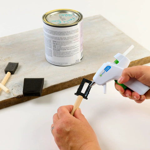 Applying glue with Low Temp Mini Hot Glue Gun 4 Pack White For Crafts And School Projects on a foam brush handle.