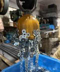 Powerful Magnetic Pickup Tool With Quick Release Lifter capturing metal washers in a workshop setting.