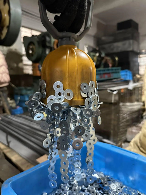 Powerful Magnetic Pickup Tool With Quick Release Lifter capturing metal washers in a workshop setting.