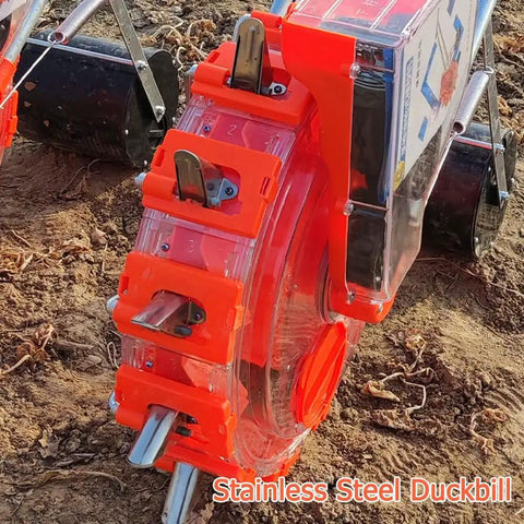 Close-up of Double Row Hand Push Garden Seeder With Nine Openings in red and stainless steel on soil surface