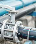 Close-up of industrial pipe fitting with nuts and bolts, showcasing use of Fully Threaded M8-1.25 Rod 450mm Stainless Steel Right Hand Studs