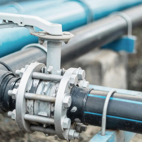 Close-up of industrial pipe fitting with nuts and bolts, showcasing use of Fully Threaded M8-1.25 Rod 450mm Stainless Steel Right Hand Studs
