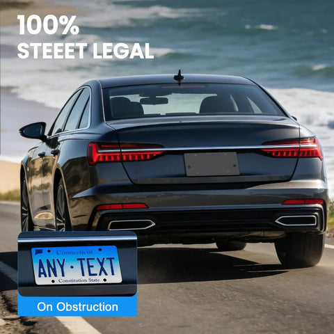 Rear view of a black car with Rear License Plate Bracket Holder Fits Audi A3 A4 A5 A6 A7 A8 S4 S5 S6 S7 RS5 RS6 RS7 Q3 Q5 SQ5 2012-2025 With Screws And Wrench Tail Bumper Tag Frame Upgrade driving by the coast.