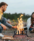14 Inch Fireplace Log Grate With Ember Retainer Heavy Duty Steel Firewood Rack in use outdoors for camping, stable four leg support