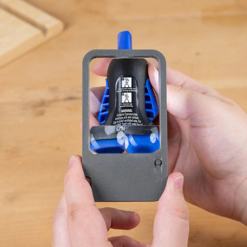 Hands holding Multi Power LED Lighted Pocket Magnifier With 2.5X Main Lens, 4.5X And 6X Lenses, showing LED light functionality