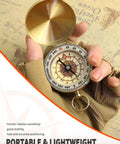 Hand holding a Waterproof Brass Compass For Hiking And Survival With Large Dial And Glow In The Dark Markings in map background