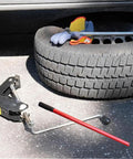 Rock Solid Vertical Hydraulic Bottleneck Jack For Cars 5 To 10 Ton Capacity Red Compact Portable Design With Tough Carbon Steel Handle next to a tire and gloves.
