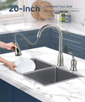 Two Hole Kitchen Faucet With Pull Down Sprayer In Brushed Nickel Finish, splashing water into a double sink, blue cabinets in background