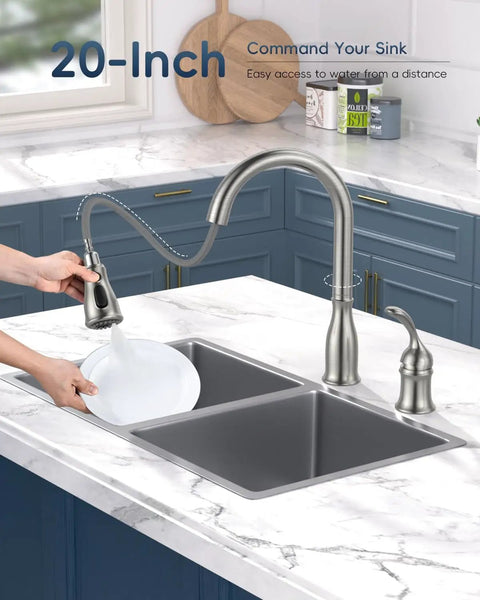 Two Hole Kitchen Faucet With Pull Down Sprayer In Brushed Nickel Finish, splashing water into a double sink, blue cabinets in background
