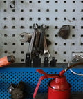 Ditch The Struggle With This Awesome 4 Piece Black Steel Socket Converter Kit! Includes Ball Bearing Adapters For Fast Drive Size Swaps And Secure Fits On Wrenches. Black steel adapter set on a pegboard with wrenches