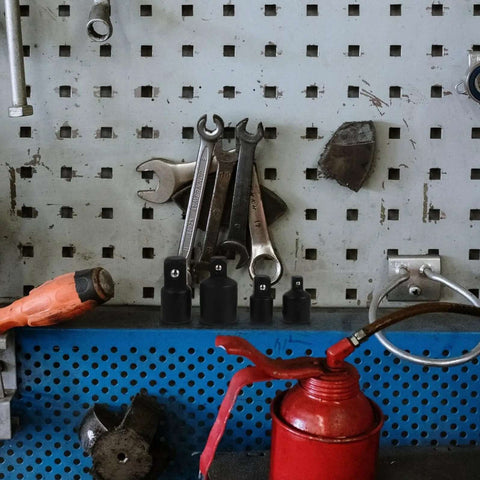 Ditch The Struggle With This Awesome 4 Piece Black Steel Socket Converter Kit! Includes Ball Bearing Adapters For Fast Drive Size Swaps And Secure Fits On Wrenches. Black steel adapter set on a pegboard with wrenches