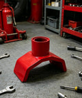 Red Beefy Bottle Jack Adapter Lifting Saddle for 2 to 4 Inch Axle Tubes in garage setting