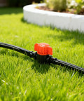 Close-up of a 25 Pack One Quarter Inch Drip Irrigation Shut Off Valve Easy Install Inline Water Flow Control on grass