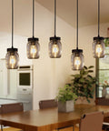 Five Light Mason Jar Chandelier With Rustic Glass Shades in kitchen dining area, highlighting hanging design and warm lighting.