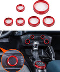 Red billet aluminum knob trim rings for Ford Bronco; multi-size bezels installed around climate and radio knobs