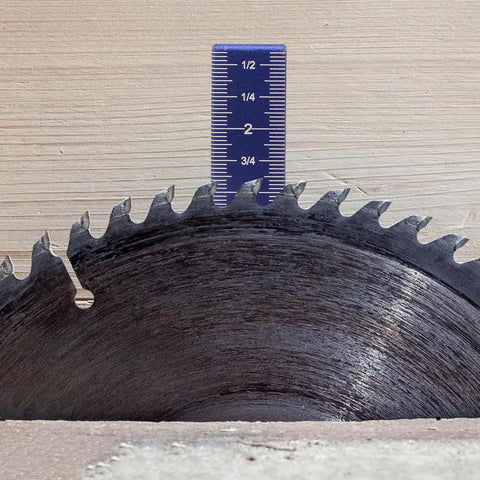 Close-up of Pro Grade Aluminum Isosceles Right Triangle Ruler With 45/90 Degree Layout next to a saw blade, showing scale details.