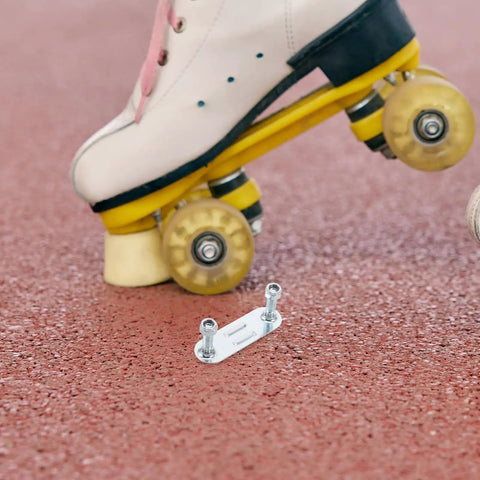 Four Piece Roller Skate Repair Parts Kit With Five Metal Plates And Mounting Hardware For Recreational Quad Skating Shock Cushion Set 20mm Fits Most Setups For All Skill Levels shown with skate on pavement.