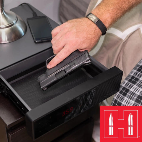 Person using nightstand gun safe with RFID reader clock and USB ports for fast touch free access discreet pistol safe
