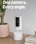 Sleek 360 Degree Pan Tilt Indoor Security Camera With Crisp Hd Video And Two Way Talk For Keeping Tabs On Your Space Plus Instant Smart App Alerts And Clean White Case For A Solid Setup You Know You Need Right Now on wooden table with plant and books