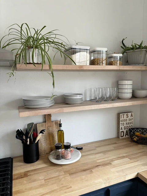 Heavy Duty Floating Shelf Brackets Fifty Eight Inches Long Invisible Mantel Supports For Thick Lumber Boards Matte Black Alloy Wall Mount Holders with potted plants and kitchenware.