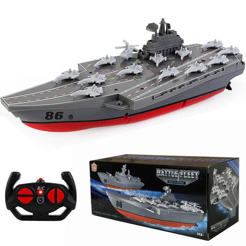 Remote Controlled Warship Battleship And Aircraft Carrier RC Boat With 4WD Dual Motors And 2.4G Radio Speeds Up To 10 Kmh Great For Lakes And Pools Ideal For Exhibits Or Military Model Collectors Beginner Friendly For Ages 14 And Up. Showcasing model with box and remote control.