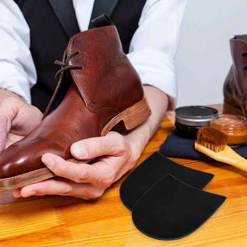Person brushing brown leather shoe with Anti Slip Rubber Shoe Sole Stickers For Men And Women, patches displayed next to shoe care kit.