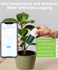 WiFi Soil Moisture And Temperature Sensor For Lawn And Garden No Hub Required Real Time App Alerts shown with plant and smartphone