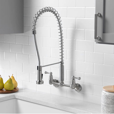 Dual Handle Pro Grade Commercial Style Wall Mount Kitchen Faucet With Pull Down Nozzle And Dual Spray Options In Stainless Steel 1.8 GPM Water Saver For Heavy Duty Kitchens Perfect For Busy Kitchens And Home Chefs installed on white tile wall.