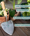 Oversized Garden Trowel With Sharp Stainless Steel Blade And Wood Handle For Transplanting Roots Digging And Potting In Indoor Or Outdoor Gardens A Rugged Rust Resistant Workhorse That Keeps Its Edge displayed with potted plants