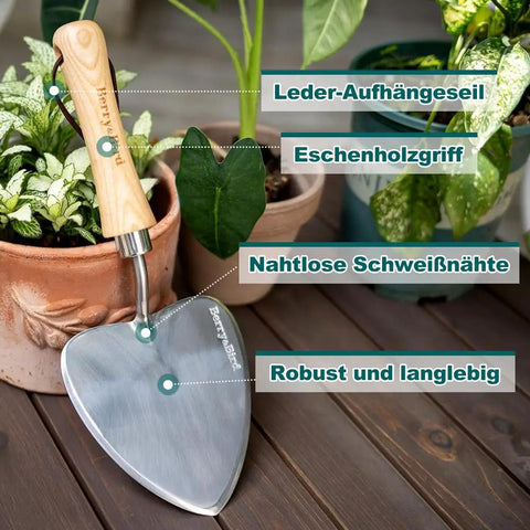 Oversized Garden Trowel With Sharp Stainless Steel Blade And Wood Handle For Transplanting Roots Digging And Potting In Indoor Or Outdoor Gardens A Rugged Rust Resistant Workhorse That Keeps Its Edge displayed with potted plants