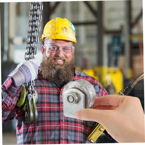 Worker holding 4-inch V-groove gate wheel in industrial setting