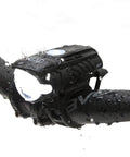 Swift 500 Front Bike Light on handlebars, showing USB rechargeable LED headlight, water droplets visible, for night cycling safety.