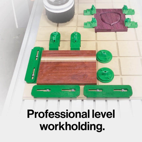 Matchfit Workholding Clamp Kit And Dovetail Router Bit Bundle With One Quarter Inch Shank displayed on a CNC workbench