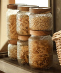 Premium Glass Coffee Canister With Secure Locking Lid Wide Mouth Kitchen Storage Jar For Beans Sugar Loose Tea Clear Airtight Food Container filled with pasta on a wooden shelf.