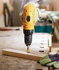 Yellow drill using the Six Piece Countersink Drill Bit Set With One Quarter Inch Hex Shank on a wooden board