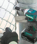 Worker using Impact XPS Three Eighths Inch Square Drive To Two Inch Socket Adapter with retention ball for high torque impact drivers.