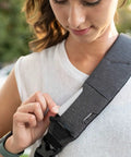 Woman adjusting strap of Lightweight 6L Crossbody Sling Bag For Travel And Everyday Carry, Anti Theft Pocket System