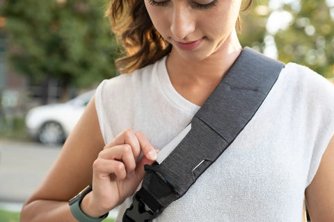 Woman adjusting strap of Lightweight 6L Crossbody Sling Bag For Travel And Everyday Carry, Anti Theft Pocket System