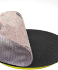 Get Your Hands On 30pcs Of The Dopest 5 Inch Mesh Sanding Discs With Hook Loop Back That Stay Cool And Clog-Free For Super Smooth Dust Free Grinding Plus Polishing Jobs At A Sweet 180grit Speed showing a hand peeling a mesh disc.