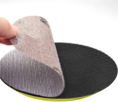 Get Your Hands On 30pcs Of The Dopest 5 Inch Mesh Sanding Discs With Hook Loop Back That Stay Cool And Clog-Free For Super Smooth Dust Free Grinding Plus Polishing Jobs At A Sweet 180grit Speed showing a hand peeling a mesh disc.