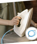 Person using steam iron with High Temperature Steam Hose For Steam Irons Replacement And Heavy Duty High Pressure Tubing