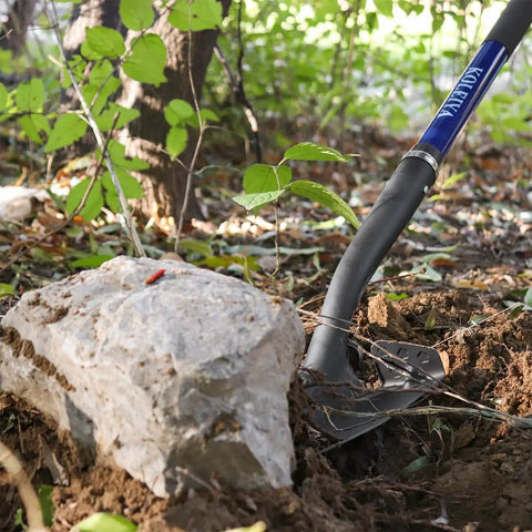 Heavy Duty Shovel With Fiberglass Handle 57 Inch Spade For Gardening, Trenching in soil next to a rock in a garden setting