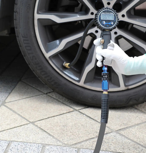 User inflating tire with Straight Shooter Hybrid Air Compressor Hose 3/8 Inch By 3 Feet Lays Flat Kink Free Rubber Pvc Build.