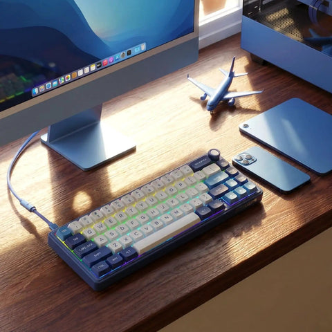 Absolute Beast 60 Percent Mechanical Gaming Keyboard With Gasket Mount And Rgb Backlighting Volume Knob Pbt Keycaps Mda Profile Qmk Via Hot Swappable Layout For Late Night Grinding And Vibing Blue Edition on a desk next to a monitor.