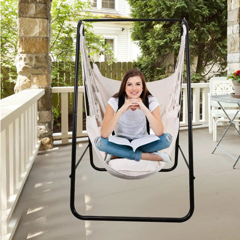 Woman sitting in a Boho Macrame Hammock Chair Hanging Rope Ceiling Swing For Indoor And Outdoor Use, Cozy Lounge For Bedroom, Balcony, Garden Or Deck