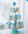 Blue Hot Air Balloon Cupcake Toppers 24 Pack With Four Pattern Set; toppers on cupcakes with balloons and clouds motifs.