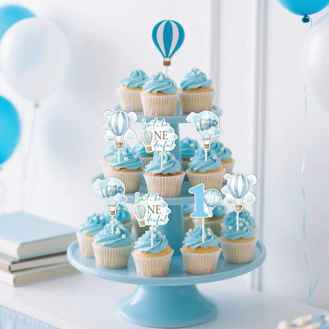 Blue Hot Air Balloon Cupcake Toppers 24 Pack With Four Pattern Set; toppers on cupcakes with balloons and clouds motifs.