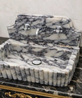 Straight Up Premium Calacatta Viola Marble Wall Mount Bathroom Sink with chrome faucet on elegant marble countertop.