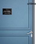 Do Not Knock Door Sign 4 By 6 Inch Durable ABS Plastic for front door, black with white text, adhesive backing shown on blue door.